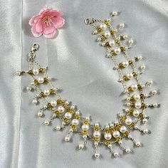 Experience the harmonious blend of natural beauty and timeless elegance with our Pearls and Crystals Symphony Necklace. Hand-crafted from freshwater pearls and crystals in various sizes, this exquisite choker-style necklace is the epitome of sophistication. The luminous natural pearls framed with golden Swarovski crystals, create a mesmerizing effect that will add a touch of glamour to any outfit, especially an off-shoulder dress or blouse. Ivory Sea Cultured Pearls Golden Swarovski Crystals Met Elegant Pearl Bracelet For Jewelry Making, Exquisite White Jewelry With Pearl Charm, Elegant Beaded Akoya Pearl Jewelry, Beaded Akoya Pearl Wedding Jewelry, White Pearl Pendant Bracelet For Wedding, Exquisite Pearl Charm Necklace, Delicate White Pearl Bracelet With Pendant, Elegant White Beaded Pearl Necklace, White Pearl Jewelry With Bead Caps