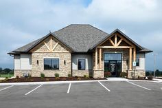 the front entrance to a large building with lots of windows and stone work on it