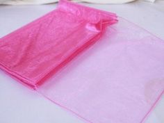 a pink plastic bag sitting on top of a white table next to a plate with food