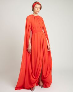 Round neckline, overlapped cape-like sleeves with draping details. Unique Prom Dresses, Coral Dress, Elevate Your Look, Hand Beading, Free Giveaway, Black Tie, Round Neckline, Orange Color, Cape