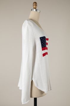 The Miss Americana White Flag Sweater will have you feeling nostalgic the second you throw it on! White lightweight knit fabric shapes this relaxed sweater with side slits and a boat neckline. Features an American flag design at the center. Throw on over a bikini as a cover-up or with jeans for day-to-day wear! DETAILS & FIT Oversized Fit. 60% Cotton, 40% Acrylic. Hand wash cold. Imported. Flag Sweater, Usa Sweater, Miss Americana, Feeling Nostalgic, Striped Vase, American Flag Design, White Flag, Blue Flag, Everyday Basics