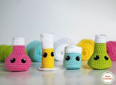 small crocheted toys are lined up on the table