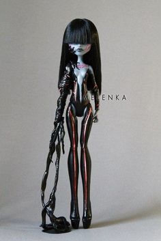 a black and white photo of a female figure with red stripes on her body, standing in front of a gray background