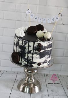 a black and white cake with oreo cookies on top