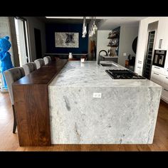 a large kitchen island with marble counter tops