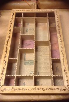 an old wooden box filled with books on top of a table