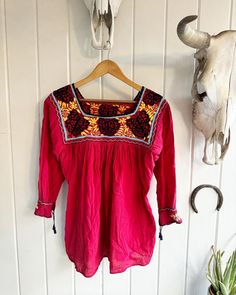 Vintage Red Embroidered Butterfly and Flower Flowing Blouse. No tags. 3/4 sleeves with ties. Black, yellow, blue, and violet embroidery on red. Length: 28.5" Underarm to underarm: approximately 22".Check out the rest of our shop: https://instagram.com/hollyshopvintage?igshid=OGQ5ZDc2ODk2ZA== https://hollyshopvintage.etsy.com/ Orders over $35 ship for free. Please check out my Instagram for my newest finds: Hollyshopvintage  Everything priced over $35 has shipping already included in the total price. I'll gladly combine shipping on multiple items to save you money, when it is safe to do so! Message me to make adjustments ahead of time, or make your purchase and I'll refund the shipping overages.  Most items are Vintage. Expect some vintage wear. Items may contain unmentioned flaws.  I only Summer Festival Blouse With 3/4 Sleeves, Red 3/4 Sleeve Summer Blouse, Red Half Sleeve Summer Blouse, Bohemian Tops With 3/4 Sleeve And Floral Embroidery, Red Long Sleeve Cotton Embroidered Top, Red Long Sleeve Blouse With Floral Embroidery, Red Fitted Bohemian Embroidered Top, Fitted Red Bohemian Embroidered Top, Red Tunic Blouse For Summer