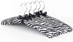 three zebra print hangers with black bows on them