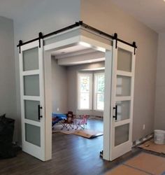 an empty room with sliding glass doors in the middle and hard wood flooring on the other side