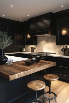 a kitchen with black cabinets and wooden counter tops, two stools in front of the island