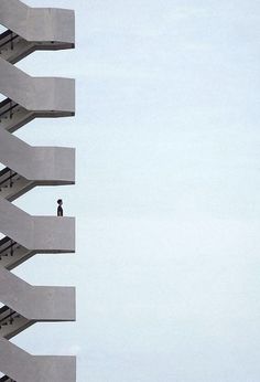 a person standing on top of a tall building