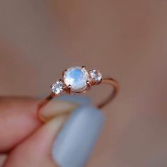 14k Solid Yellow Gold Engagement Ring / Handmade Jewelry Rainbow Moonstone White Topaz Gemstone Ring Wedding Gift Ring Minimalist Dainty Ring ✦ Description ✦  * 14k & 18k Solid Gold With Stamped  * Gemstone : Natural Rainbow Moonstone  * Moonstone Size : 5 mm * Side Stone : Natural White Topaz  * Topaz Size : 2.5 mm * 14K Solid Yellow Gold, ( Available in 14K & 18K Yellow, Rose, and White Gold ) * Option available in 18K Gold * All size available * Ready to Ship in 1-2 Weeks ≫ FAQ below for more detail. ✦ Sizing We can adjust most items to fit your sizing preferences. Most items can be made to any size and length. Please leave a note at checkout or contact us via Etsy conversation. Even after purchasing the item, you can still ask us to adjust the size or length. We will try our best to fi Yellow Gold Engagement Ring, Handmade Engagement Rings, Zierlicher Ring, Yellow Gold Engagement, Yellow Gold Engagement Rings, Ring Minimalist, Natural Rainbow, Gold Engagement Ring, Gift Ring