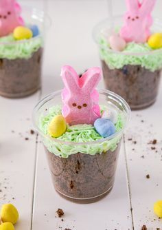 three small plastic cups filled with chocolate pudding and decorated peep - poop