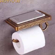 a cell phone is sitting on top of a roll of toilet paper