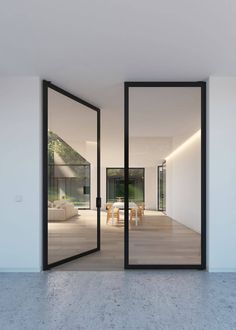 an instagramted photo of a modern house with open glass doors and white walls