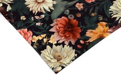 a black and orange floral necktie with white flowers on the front, green leaves in the back