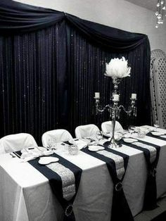 the table is set with black and white linens