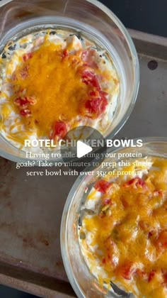 two glass bowls filled with food sitting on top of a metal tray next to each other