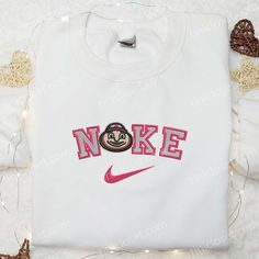 Ohio State Buckeyes x Nike Embroidered Shirt, NCAA Sports Embroidered Hoodie, Best Gift Idea Nestled within the vibrant tapestry of urban life, Tinicloset stands as an embodiment of sartorial elegance and sporting spirit, a sanctuary where threads intertwine to weave tales of tradition, pride, and unyielding excellence. From the moment one crosses the threshold into this haven of personalized fashion, they are enveloped in a symphony of colors and textures, each garment bearing the hallmark of m Ohio State Embroidery Designs, Embroidered White College Hoodie, Sporty Embroidered Sweatshirt For Sports Season, Embroidered Crew Neck Sports Hoodie, Embroidered Crew Neck Hoodie For Sports, Sporty Cotton Sweatshirt With Machine Embroidery, Hooded Sweatshirt With Machine Embroidery For Streetwear, Embroidered College Sweatshirt For Sports Season, Embroidered Sweatshirt For College Sports Season