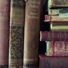 several old books are stacked on top of each other