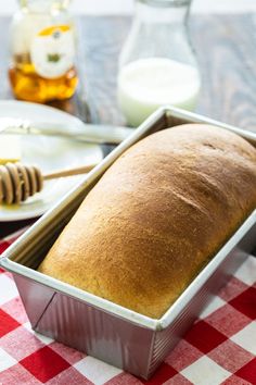 a loaf of bread sitting on top of a red and white checkered table cloth