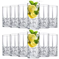 four shot glasses filled with lemon slices and mint