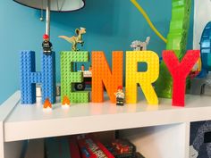 the word henry spelled out with legos and toys on top of a white table