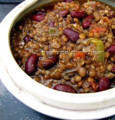 a bowl filled with beans and vegetables on top of a table