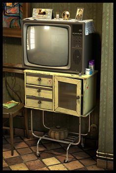 an old fashioned television sitting on top of a dresser