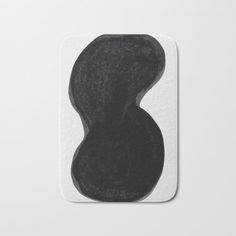 a black and white photo of a piece of artwork on a bath mat that is shaped like an oval