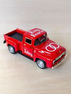 a red toy truck with the number eight painted on it