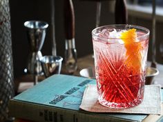 a red drink sitting on top of a book