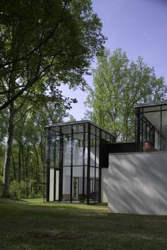 the modern house is surrounded by trees and grass