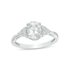 Set a sophisticated tone in this glamorous fashion ring. Crafted in sterling silver, this timeless design features an 8.0 x 6.0mm oval-shaped lab-created shimmering white sapphire flanked by trios of diamond accents - each artfully set to enhance size and sparkle. Buffed to a brilliant luster, this look glistens with elegance. Custom-made to fit her ring size. Sterling silver rings cannot be resized after purchase. White Rings With Accent Stones For Formal Occasions, Formal White Rings With Accent Stones, Classic White Diamond Ring With Accent Stones, Timeless White Topaz White Rings, Classic White Rings With Accent Stones, Formal White Topaz Ring With Cubic Zirconia, White Oval Diamond Ring With Prong Setting, Elegant White Rings With Accent Stones, Timeless White Jewelry With Accent Stones