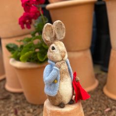 a toy mouse sitting on top of a potted plant