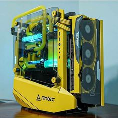 a yellow computer case sitting on top of a wooden table