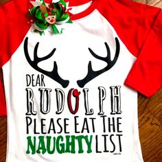 Dear Rudolph Please Eat The Naughty List Saying Across Front Of Top. A White Next Level Raglan Style With Red Sleeves. A Heat Transfer Of Rudolph Antlers With Cute Saying. Outfit Complete For The Girls A With Coordinating Bow That Is Included In Purchase. Shirt Could Be Unisex Too For Little Boys Without The Bow Of Course. Same Day Shipping If Purchases By 3pm Central. Smoke Free Home Boutique Christmas Shirt Ideas Vinyl For Kids, White Letter Print Top For Holiday, White Letter Print Tops For Holiday, Cute White Holiday Tops, Cute White Christmas Tops, White Letter Print Shirt For Holiday, Cute White Top For Festive Occasions, White Christmas Shirt With Letter Print, White Christmas Letter Print Shirt