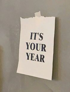 a piece of paper with the words it's your year written on it hanging on a wall