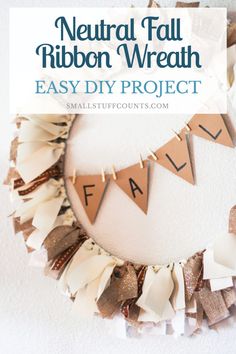 a wreath made out of fabric and ribbon with the words neutral fall ribbon wreath easy diy project