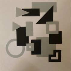 an abstract painting with black and white squares, rectangles, and rings on it