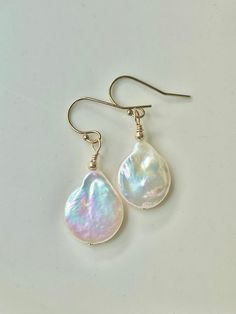 "Dainty 14k gold filled ear wires have sweet, luminous freshwater pearl dangles... like decadent whipped frosting! The approx 1/2\" wide pearls are all special & individually glowing with faint multi-colors. Pearls symbolize purity, harmony & humility, plus being the birthstone for June. A special occasion earring, a bridal choice or simply a pair of earrings to wear with anything at anytime. Each pair is unique- chose your fav at check out. These pearl dangles were created uniquely in my Seattl Multicoloured Earrings, Whipped Frosting, Natural Pearl Earrings, Bridal Gift, Funky Jewelry, Pearl Earrings Dangle, Natural Pearls, Cute Earrings, Gift Giving