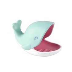 a toy whale with its mouth open on a white background