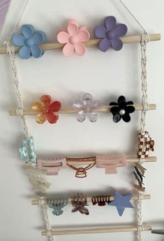 a bunch of different colored hair clips hanging on a wall