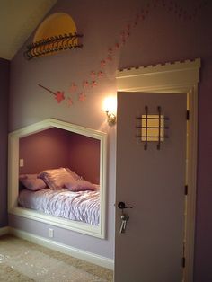 a bedroom with purple walls and a white bed in the corner next to an open door