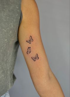 three butterflies tattoo on the arm