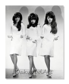 three women in white dresses standing next to each other