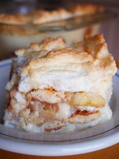 a piece of pie sitting on top of a white plate next to a glass bowl