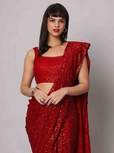 Wear this stunning red sequins georgette cocktail party wear a saree with a blouse and make heads turn at any event. Designed with intricate sequin work and a beautiful sequin floral border, this saree is made from high-quality georgette material that ensures comfort and elegance. The heavy sequin work on both the saree and blouse adds a touch of glamour to your outfit, making it perfect for parties and receptions.
This designer saree comes in a vibrant red color that exudes grace and sophistica Glamorous Festive Pre-draped Saree For Celebration, Bollywood Style Festive Pre-draped Saree With Sequins, Sequin Pre-draped Chinon Saree, Bollywood Style Pre-draped Saree With Sequins, Pre-draped Saree With Dupatta For Navratri Party, Glamorous Sequined Pre-draped Saree For Festivals, Party Wear Pre-draped Sequined Saree For Festivals, Sequin Chinon Pre-draped Saree For Diwali, Party Pre-draped Chinon Saree With Mirror Work