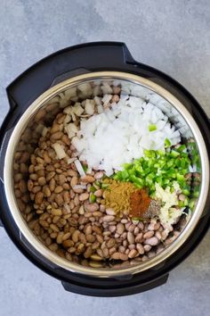 the ingredients for this meal are mixed in an electric pressure cooker, including onions, celery, and beans