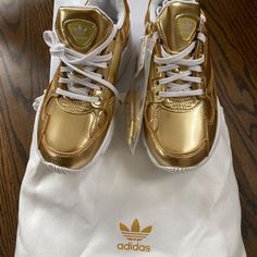 New In Box With Tags Gold Adidas Women’s Falcon. They Run A Little Large For Me. I’m A Street Size 6. Cleaning Out My Closets. All Purchases Are Recorded Including Shipping Label And Packing To Support Safe Delivery To Final Destination. Adidas Oswego, Gold Tennis Shoes, Adidas Soccer Shoes, Adidas Gold, Adidas Ultraboost 20, Adidas Falcon, Adidas Ozweego, Gold Adidas, White Tennis Shoes